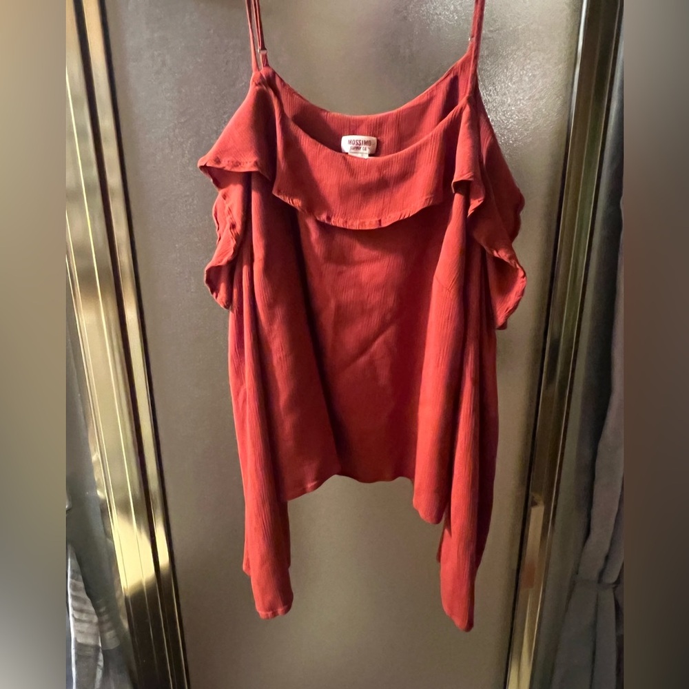 Cute top with flowing materials, shoulder cut out with quarter sleeve.